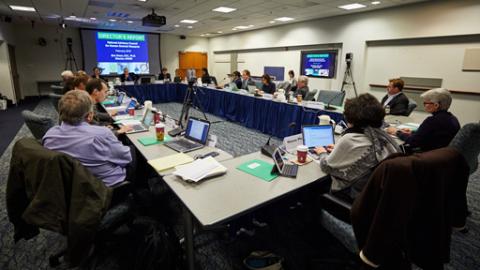 Staff sitting around table in meeting